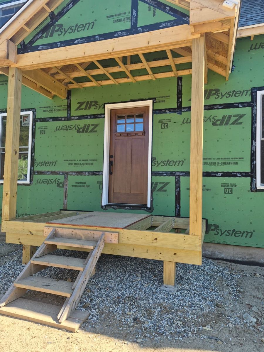 Framed covered porch and craftsman entry on a home